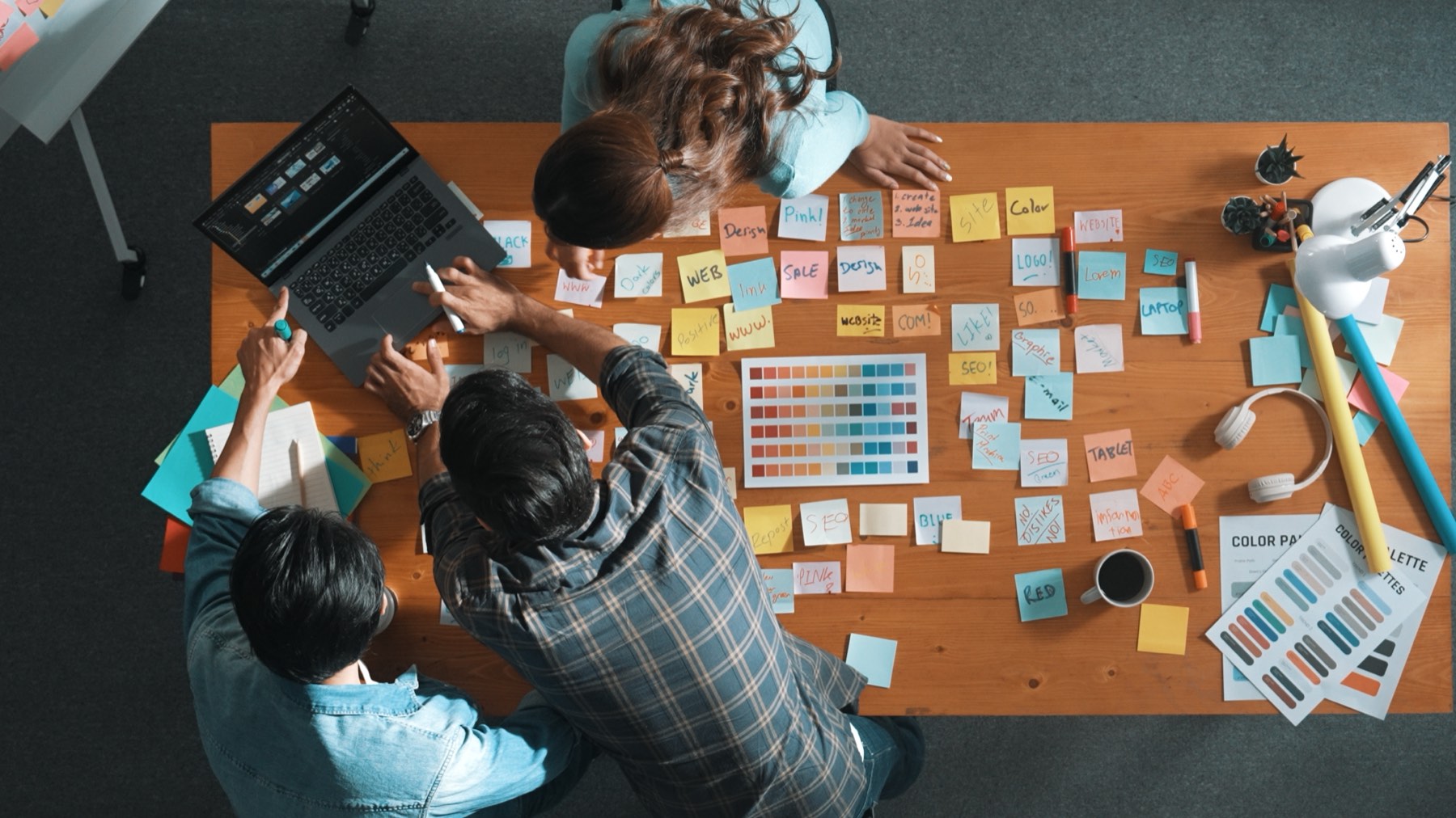 Creative team planning content with notes and layouts